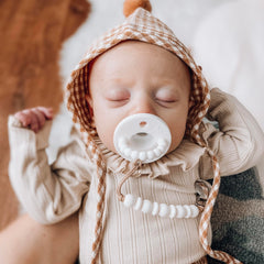 Ryan & Rose Cutie PAT hideaway binky open illustrates discreet storage during travel and naps.