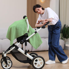 Seejoy city green canopy in use provides sun and wind protection for baby.