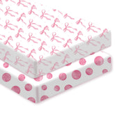 Sel Natural pink bow crib sheet on crib showing secure fit for naps