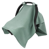 SERAPHY green muslin car seat cover provides gentle sun protection.