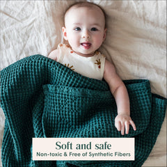Simka Rose waffle baby blanket on crib, neutral color matching any nursery.