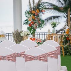 SINSSOWL wedding decor setup with chairs wearing rose gold sashes