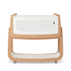 SnuzPod5 bedside bassinet assembly beside bed for easy nighttime access.