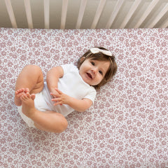 Sorrel + Fern neutral antique rose sheets on standard crib mattress for snug fit.