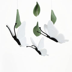 Sorrel + Fern white butterfly mobile over crib supports a gentle bedtime routine