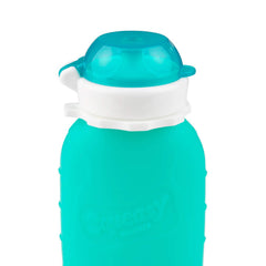 Squeasy Snacker Aqua 6oz leak-proof cap in travel setup ensuring mess-free trips