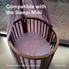 Stokke Sleepi Mini fitted sheet V3 Lavender folded shows tidy nursery storage and easy laundering.