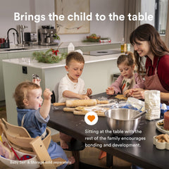 Stokke Tripp Trapp warm brown adjusted position demonstrates versatile seating for toddlers and adults.