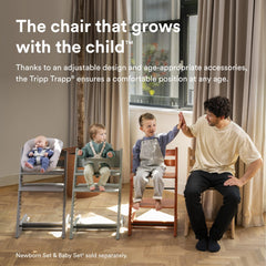 Stokke Tripp Trapp warm brown side view showing extended footrest for ergonomic seating.