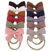 Sugarmelon linen bow headband on newborn with skin-friendly soft fabric.