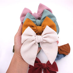 Sugarmelon velvet bow close-up showing serged edges and soft texture.