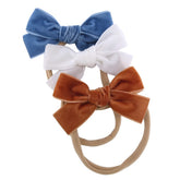 Sugarmelon velvet bow headband newborn ambrosia close-up shows soft stretchy fit for newborns.