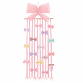 Suncalla long bow holder in pink keeps baby hair accessories organized and easy to reach.