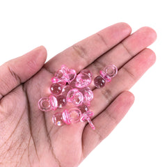 Super Z Outlet pink mini pacifiers shown as gift-table decor and party favors.