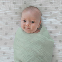 SwaddleDesigns Oceana muslin swaddle blanket during tummy time for comfy play.