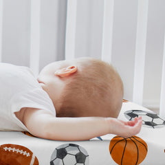 Sweet Jojo Designs sport-theme bassinet sheets blue watercolor print adds playful nursery flair.