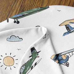 Sweet Jojo Designs nursing cover on a pillow in a cozy nursery setup.