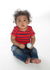 SweeTooth teether in hand demonstrates ergonomic grip for tiny fingers