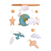 Sweety Baby airplane mobile with globe and clouds above crib for travel-inspired nursery decor.