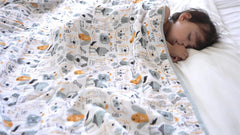 TADO MUSLIN swaddle blanket rhinoceros-design supports breathable warmth during sleep and tummy time.