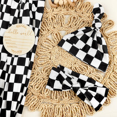 TANOFAR headband in black checkerboard coordinates with the blanket for gentle baby styling.