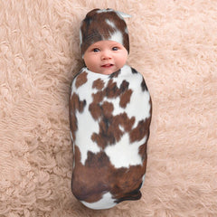 Tebjh cow print swaddle closeup reveals soft fabric and stretch