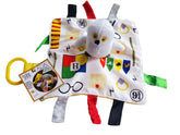 The Learning Lovey wizard owl tag toy with house colors supports visual and cognitive play.