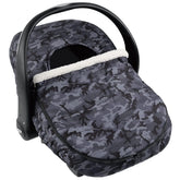 The Peanutshell car seat cover in use providing 360-degree warmth for baby