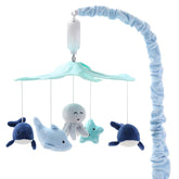 The Peanutshell crib mobile with ocean-animals spins softly to soothe baby.