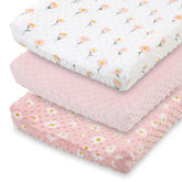 The Peanutshell daisy floral changing pad cover in pink keeps diaper changes cozy.