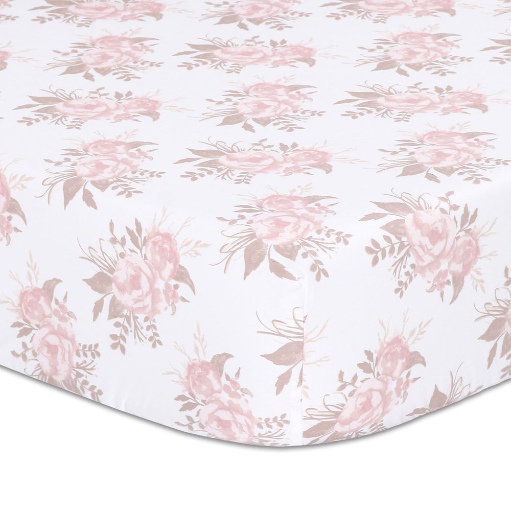 The Peanutshell Grace floral crib sheet in pink prints a soft, breathable surface for cozy naps.