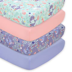 The Peanutshell Ocean Girl crib sheet packshot shows lavender, coral, pale aqua patterns for a serene nursery.