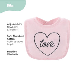 The Peanutshell Rainbow Floral bib set on a baby demonstrates full coverage for drool and spills.