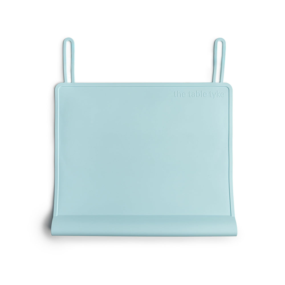 The Table Tyke edge bumper placemat shields delicate gums from sharp table edges during meals.