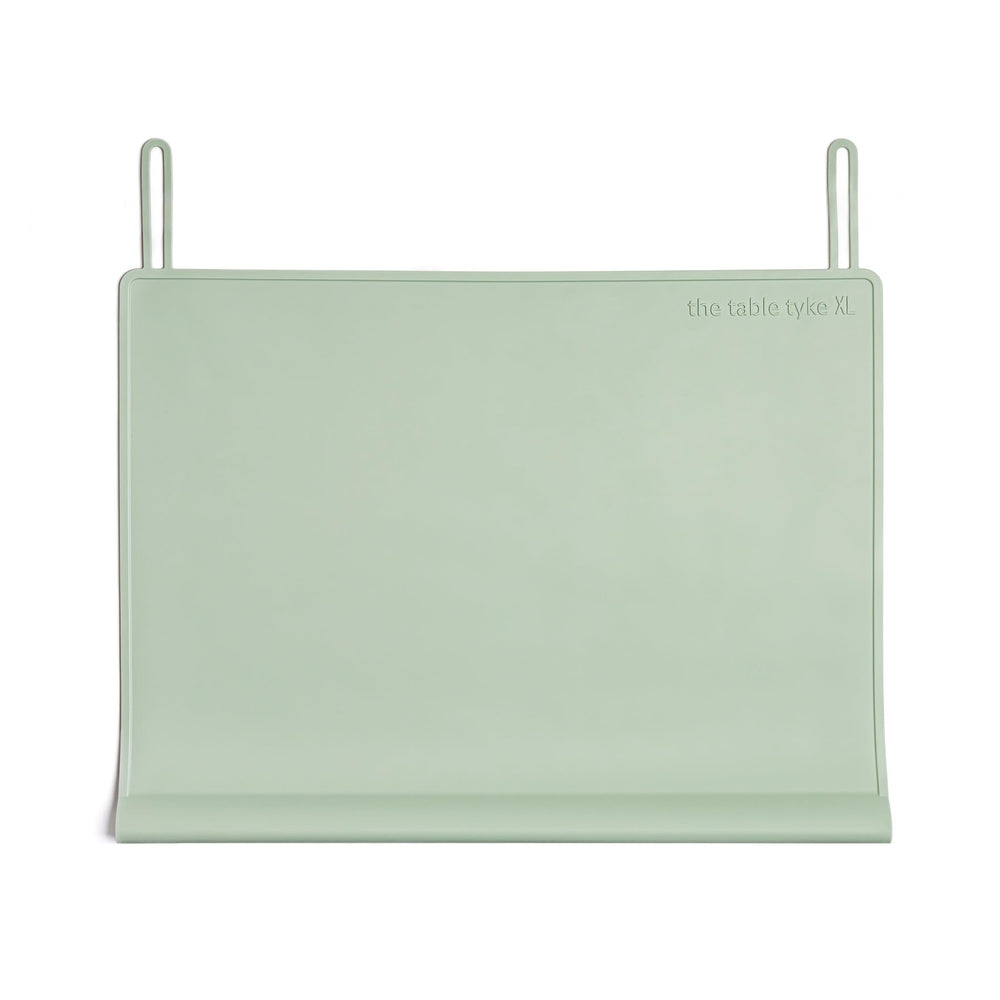 The Table Tyke XL placemat in sage green with teething edge cushions little mouths during meals.