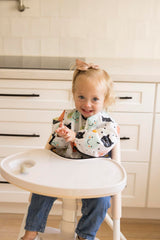 Tiny Twinkle baby bib cuffs detail highlights gentle elastic cuffs for comfy bending during meals
