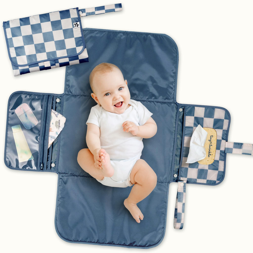 Tiny Twinkle changing pad folded blue checkers offers compact travel-ready convenience for on-the-go changes.