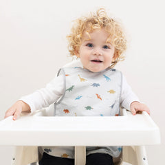 Tiny Twinkle dinosaur bib back view highlights waterproof barrier for spills.