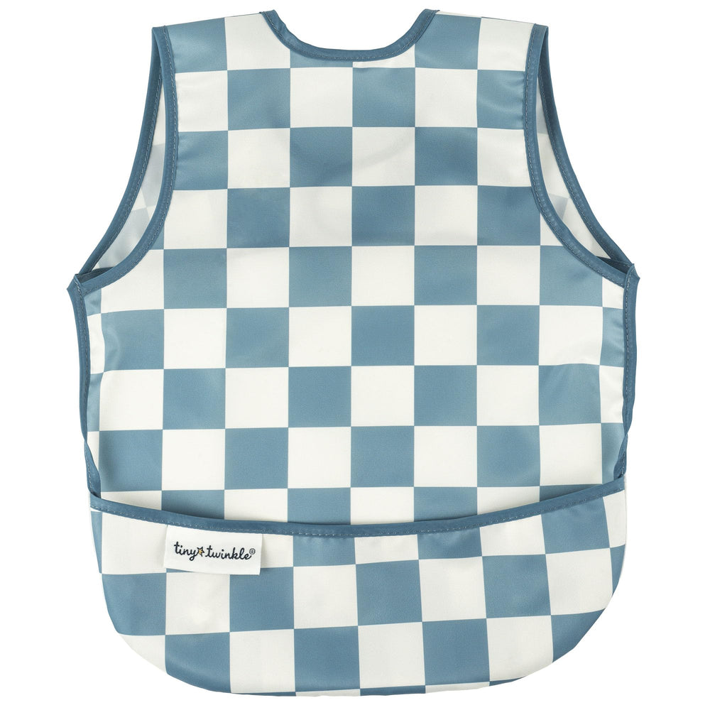 Tiny Twinkle mess-proof bib in blue checkers on a boy for reduced cleanup during meals.