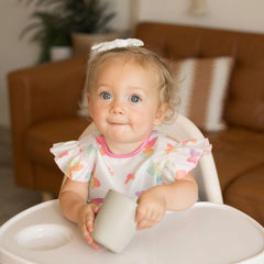 Tiny Twinkle mess-proof bib butterflies side view highlights slim profile for comfortable movement.
