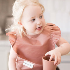 Tiny Twinkle Safari bib waterproof fabric demonstrates wipe-clean convenience