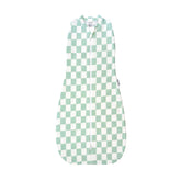 Tiny Twinkle sleep sack sage checkers close-up showing secure swaddle transition.