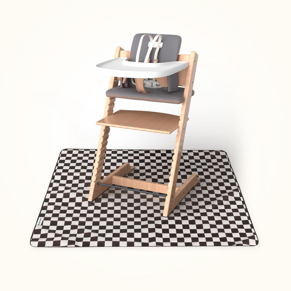 Tiny Twinkle Splat Mat under high chair protects floors during meals.