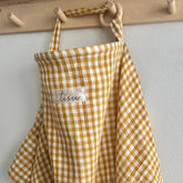 TISU nursing cover front view in mustard gingham highlighting breathable muslin for privacy