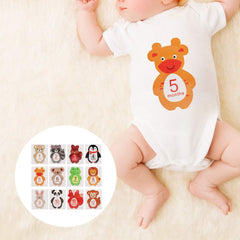 Tnfeeon baby monthly sticker set on flat lay showcases cute animal designs for photos.