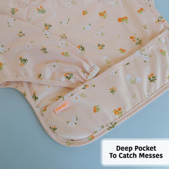 Torange baby smock bib shows adjustable neck for a growing child.