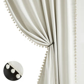Treatmentex natural blackout curtains with ivory pom pom border for privacy.