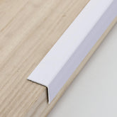 Trimold aluminum peel-and-stick L-molding corner guard on wall corner provides durable protection.
