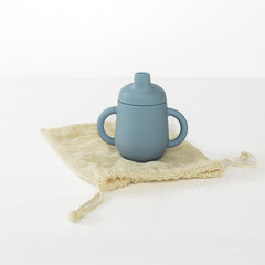TushBaby Training Cup with easy-grip handle supports early self-feeding and coordination.