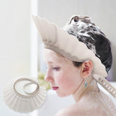 UMUACCAN baby shower cap shield worn during bath protects eyes and prevents splashes.